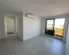 Unfurnished room with a wall mounted AC and baseboards