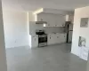 Kitchen with a sink, electric panel, under cabinet range hood, stainless steel appliances, and decorative backsplash