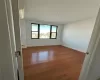 Empty room with baseboards and wood-type flooring