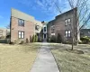 View of front of house featuring a front yard, cooling unit, and brick siding