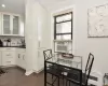 Dining room featuring dark wood-type flooring, baseboard heating, and crown molding