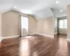 Bonus room featuring lofted ceiling, visible vents, baseboards, and wood finished floors