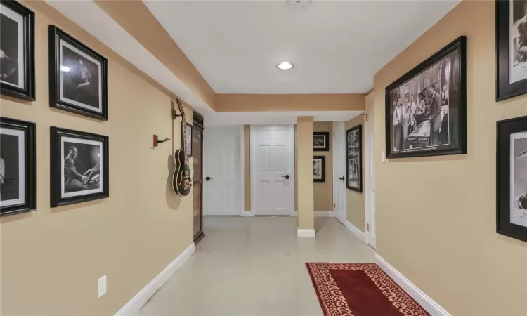 Hall with light tile patterned floors, baseboards, and recessed lighting