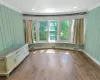 Unfurnished room featuring wood-type flooring, visible vents, and baseboards