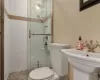 Full bathroom in the second bedroom with a sink, a shower stall, and toilet