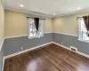 Second bedroom on the first floor featuring recessed lighting, wood finished floors, visible vents, baseboards, and ornamental molding