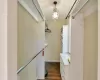 Spacious closet with dark wood-style flooring and an inviting chandelier in the primary bedroom