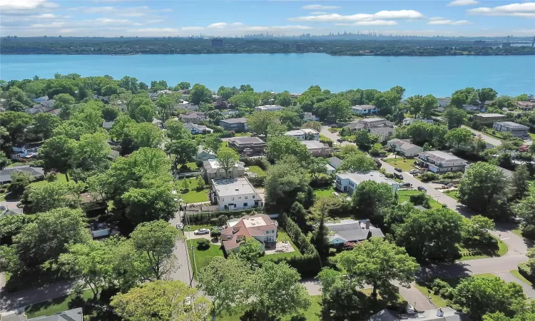 Birds eye view of property with a water view