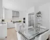 Kitchen featuring a kitchen bar, wall chimney exhaust hood, modern cabinets, and appliances with stainless steel finishes