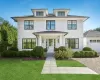 Traditional style home featuring a front lawn and an attached garage