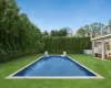 View of swimming pool with fence, a fenced in pool, and a yard