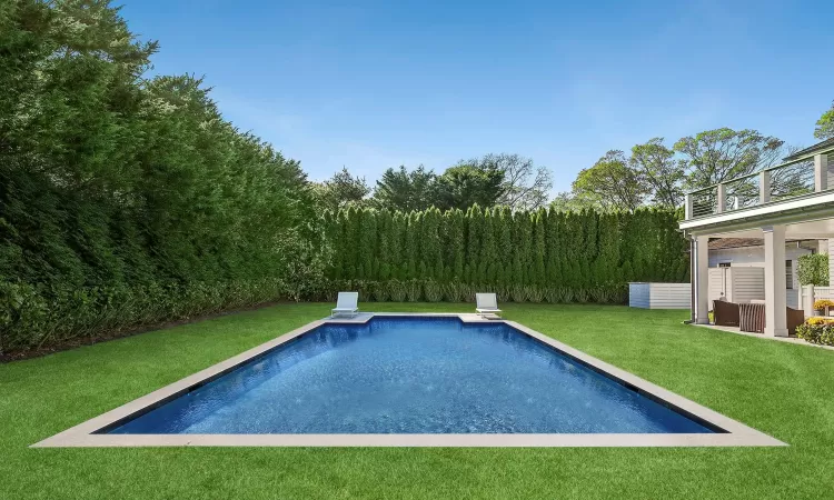 View of swimming pool with fence, a fenced in pool, and a yard