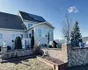 Back of property with a shingled roof and roof mounted solar panels