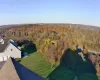 Aerial view featuring a forest view