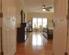 Bedroom with light wood finished floors, baseboards, ornamental molding, and ceiling fan