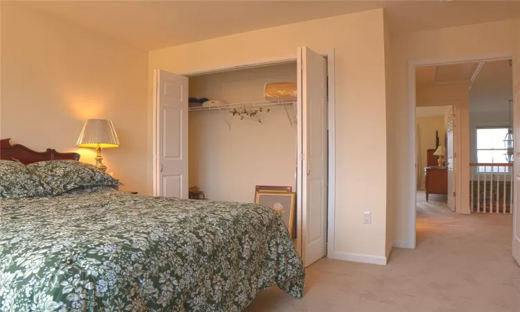 Bedroom with carpet, a closet, and baseboards