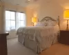 Bedroom featuring baseboards, visible vents, and light colored carpet