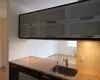 Kitchen featuring light stone counters and a sink