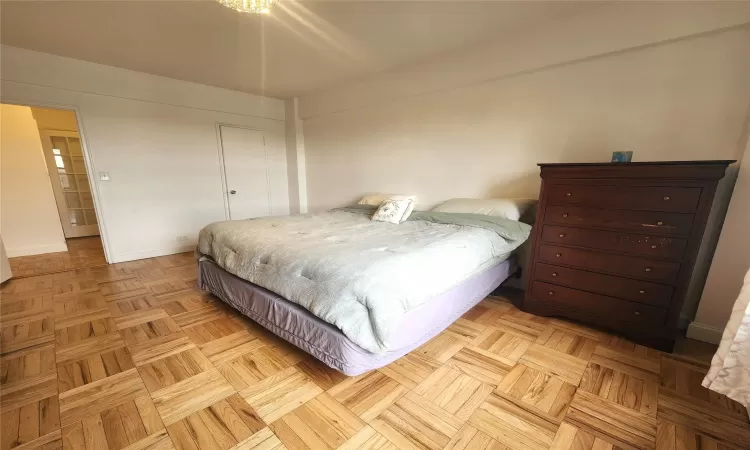 Bedroom featuring radiator heating unit and baseboards