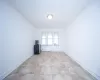 Empty room with light tile patterned flooring and baseboards