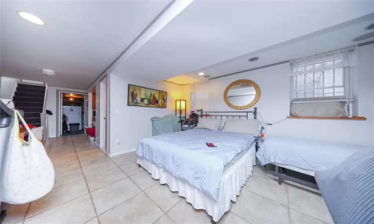 Bedroom with light tile patterned floors, recessed lighting, and baseboards