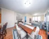 Living area featuring wood-type flooring, ornamental molding, and baseboards