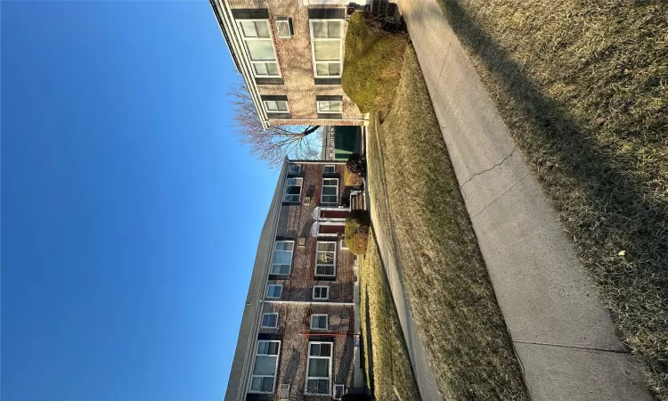 View of front of property with brick siding and a front lawn