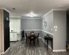 Dining area featuring dark wood-style floors, visible vents, crown molding, and baseboards