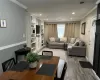 Living area featuring recessed lighting, finished wood style floors, visible vents, and crown molding