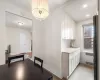 Dining room with recessed lighting, radiator, an inviting chandelier, light tile patterned flooring, and baseboards