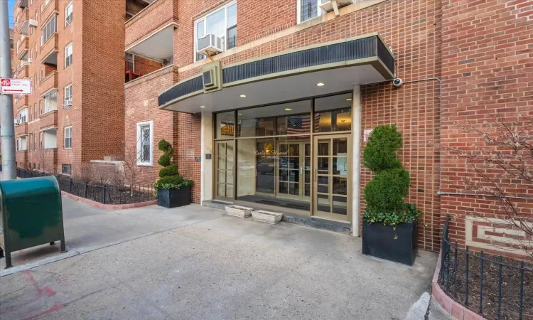 Doorway to property featuring french doors and brick siding