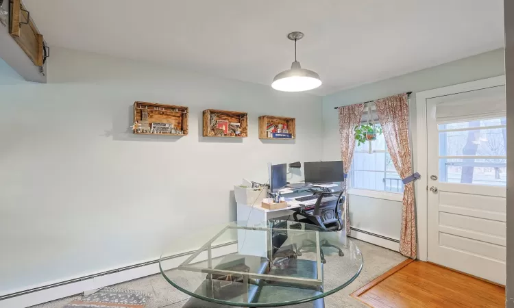 Office area with baseboard heating and wood finished floors