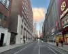 View of road with a view of city, curbs, street lights, and sidewalks