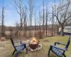 View of yard with an outdoor fire pit.