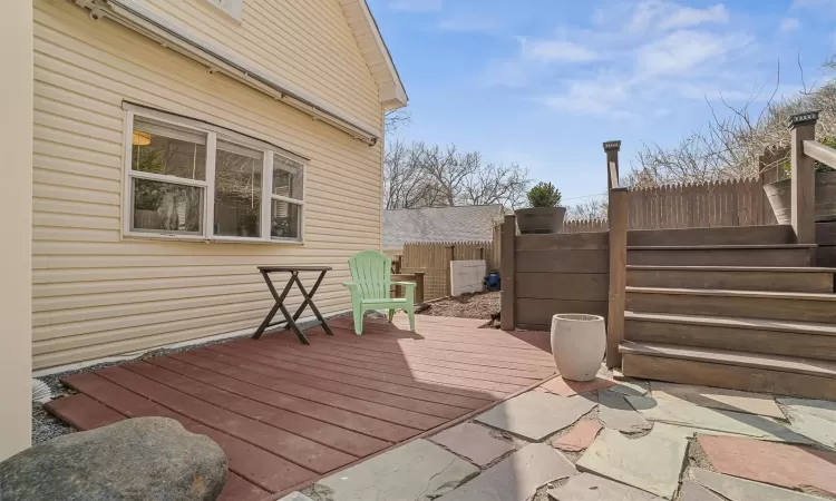 Small deck in front of home with retractable awning.