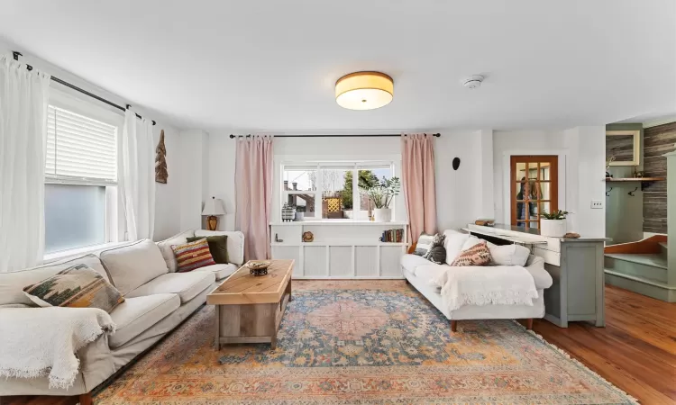 Sun filled living room with large windows.  Laminate flooring throughout the main level.