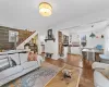 Living room featuring wood walls, stairway, and laminate floors.