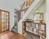 Stairs with plenty of natural light, wooden walls.