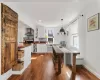 Dining area.  Dining table is made with original reclaimed lumber from the home.  Laminate flooring throughout.