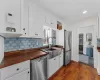 The kitchen is accented with custom shelves.  Oversized stainless steel farm sink!