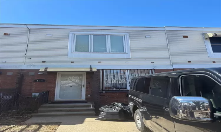 View of front of house featuring entry steps and brick siding