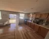 Kitchen featuring light countertops, light wood finished floors, a sink, and brown cabinets