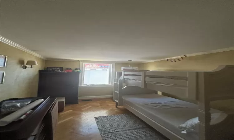 Bedroom featuring visible vents, baseboards, and crown molding