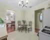 Dining space with baseboards, crown molding, visible vents, and a notable chandelier