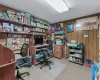 Carpeted home office with wooden walls