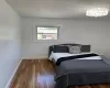 Bedroom with baseboards and wood finished floors