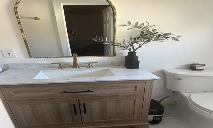 Half bath with vanity and toilet