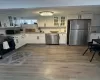 Kitchen featuring a sink, visible vents, light countertops, appliances with stainless steel finishes, and decorative backsplash