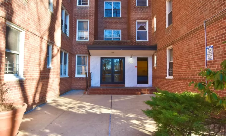 Property entrance featuring brick siding