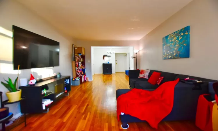 Living room featuring an inviting chandelier and wood finished floors